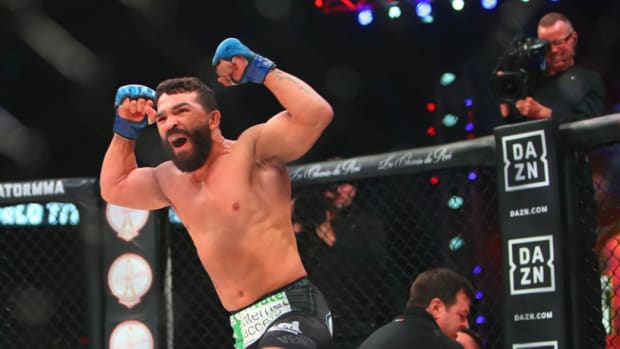 Patrício ‘Pitbull’ Freire, shirtless, raises his arms above his head